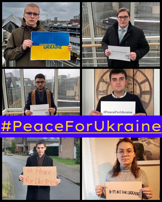 Sprecher*innenteam mit Schildern mit der Aufschrift "#PeaceForUkraine"